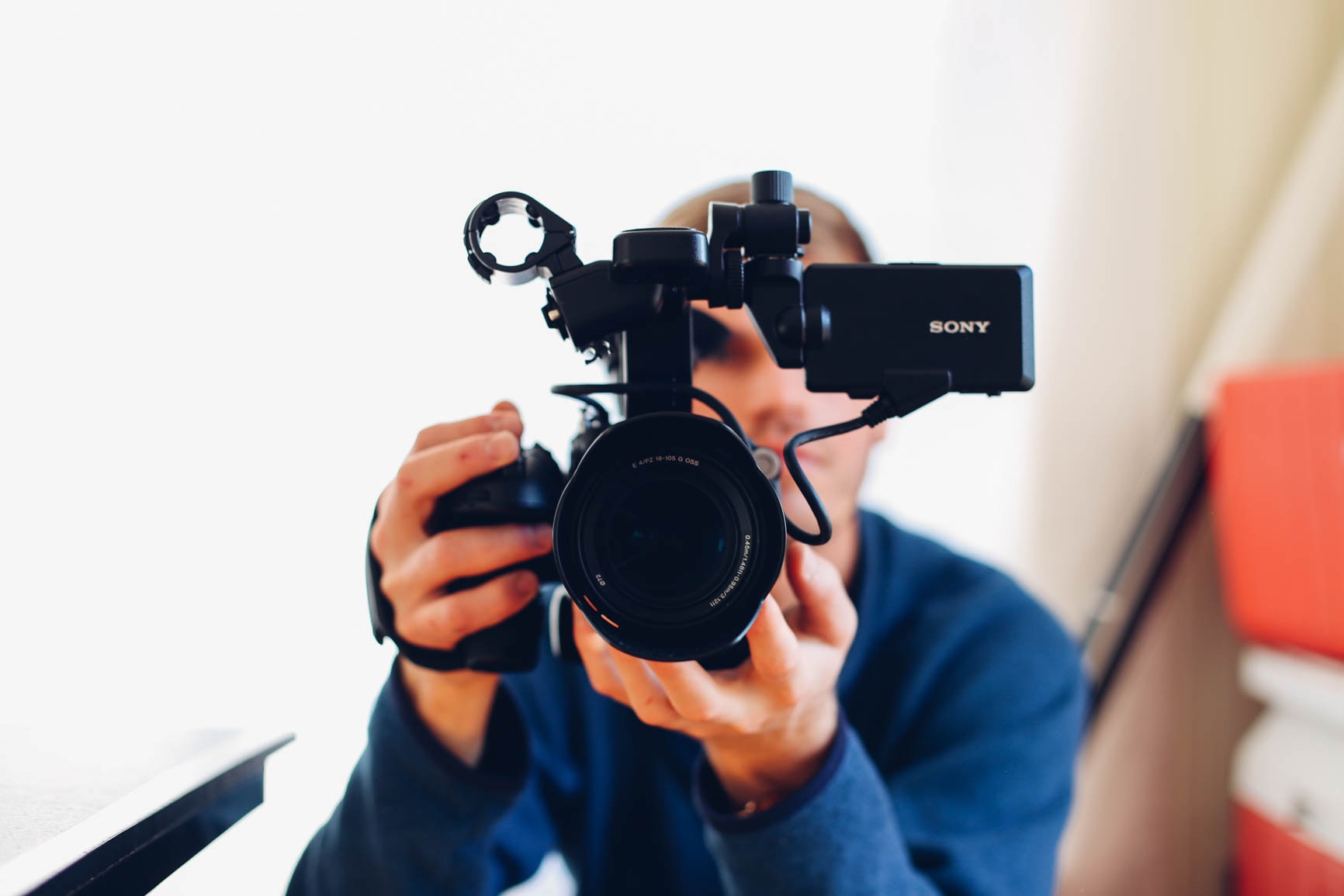 A videographer holding a camera